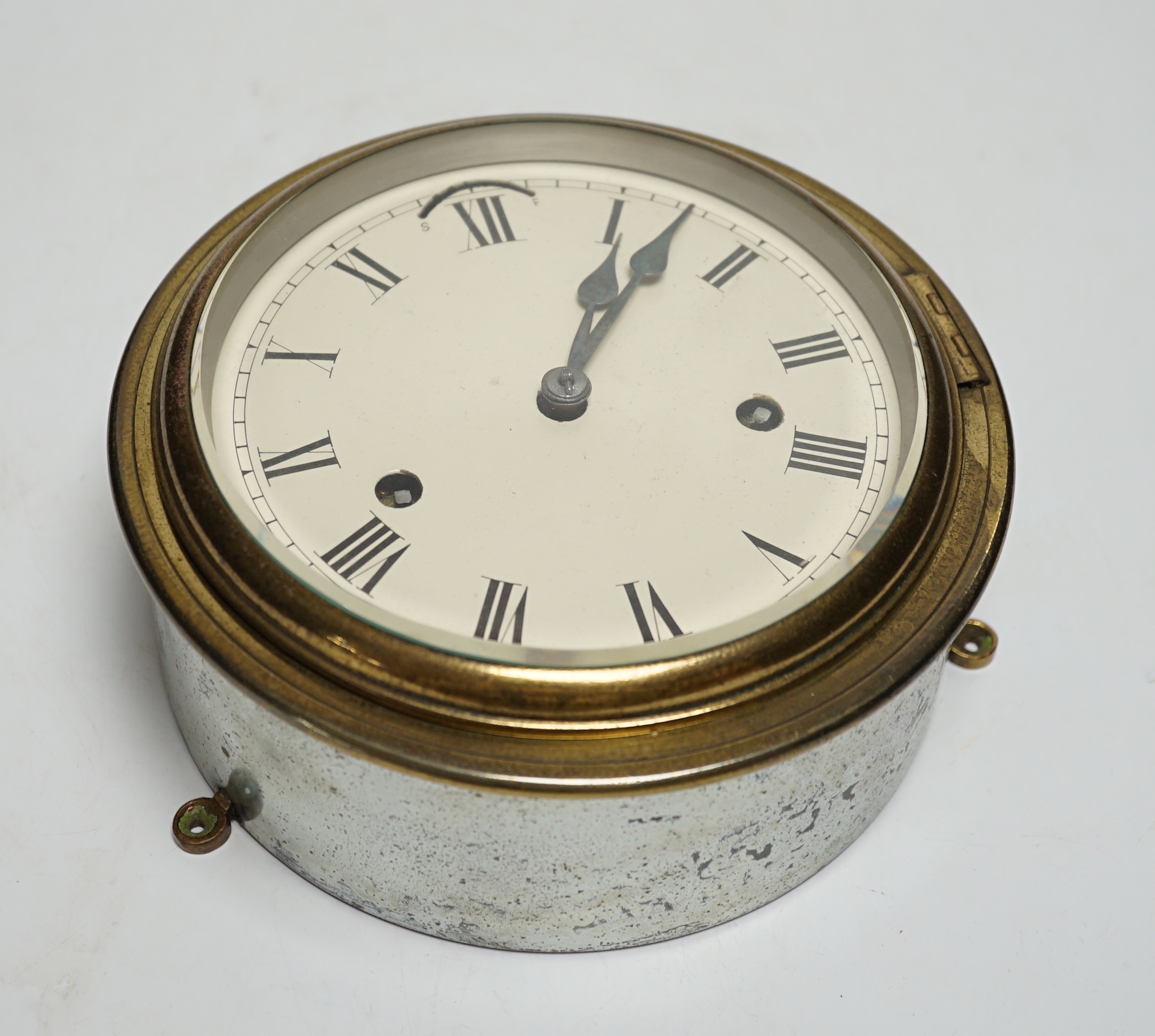 A ship's cylindrical brass two train bulkhead clock, 18.5cm diameter